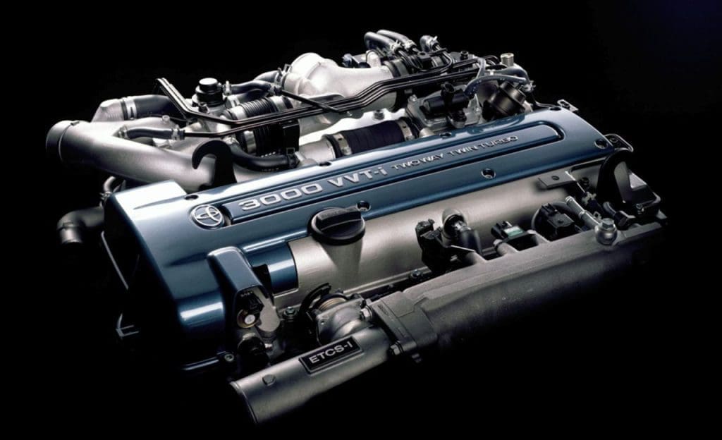 Close-up of a blue-painted Toyota 3.0L VVT-i engine with ETCS-i, shown on a dark background.