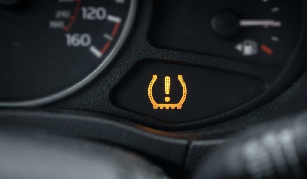 Img3013 | ยางรถยนต์ ราคาอัปเดต 2026 ครบทุกยี่ห้อ รวมยาง Ev | Autotirechecking Tire pressure warning light illuminated on the car dashboard, indicating low tire pressure