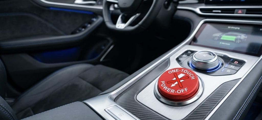 Img3166 | ยางรถยนต์ ราคาอัปเดต 2026 ครบทุกยี่ห้อ รวมยาง Ev | Autotirechecking Red circular One-Touch Power-Off button on a car center console, with surrounding controls and gear selector nearby.