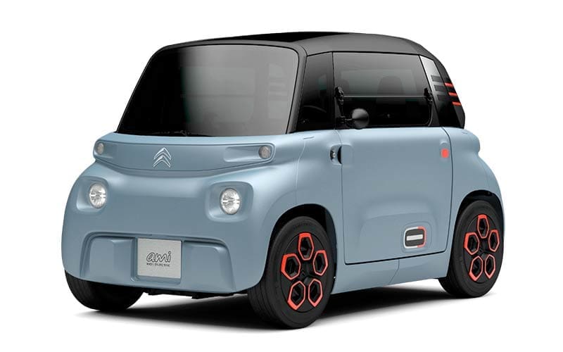 Light blue compact electric car with a black roof and red-accented wheels, facing left on a white background.