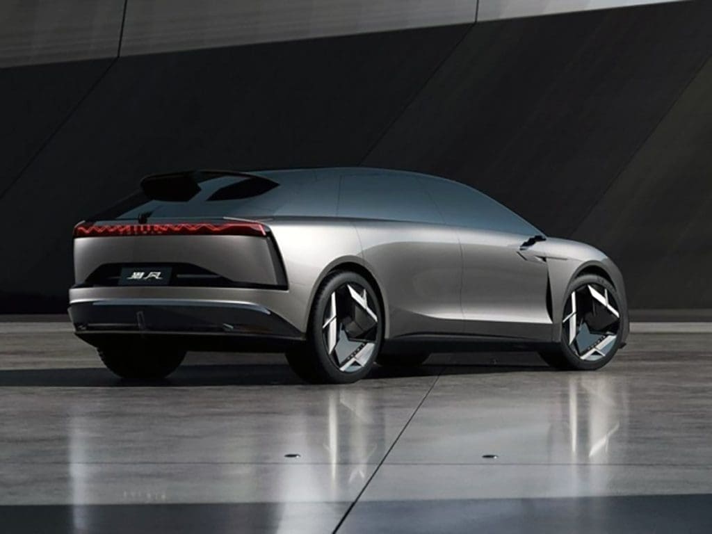 Rear three-quarter view of a silver futuristic concept car on a reflective tile surface with seamless design.