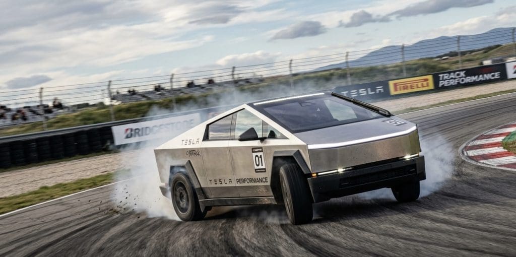 Tesla performance race car drifting on a racetrack, tire smoke rising, number 01 visible with track barriers in the background