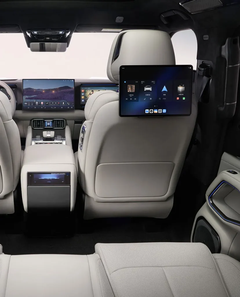 Luxurious SUV interior with rear-seat tablets mounted on the headrests and a center console screen behind the front seats of white leather seating] I think I made a mistake: need clean strings.