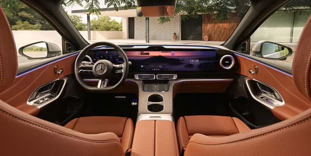 Img4598 | ยางรถยนต์ ราคาอัปเดต 2026 ครบทุกยี่ห้อ รวมยาง Ev | Autotirechecking Luxurious car interior with tan leather seats, wide digital dashboard, center touchscreen, and chrome accents.