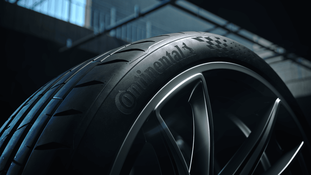 Img4661 | ยางรถยนต์ ราคาอัปเดต 2026 ครบทุกยี่ห้อ รวมยาง Ev | Autotirechecking Close-up of a Continental tire mounted on a silver alloy wheel in a dim garage setting.
