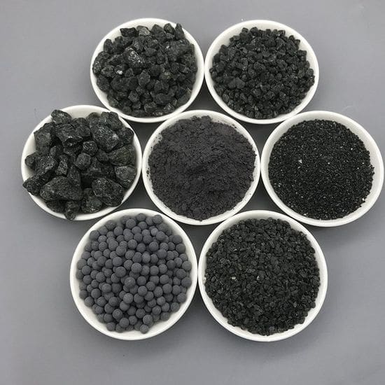 Seven white bowls arranged in a circle on a gray surface, each containing a different form of black charcoal/activated carbon (chunks, granules, powder, pellets).