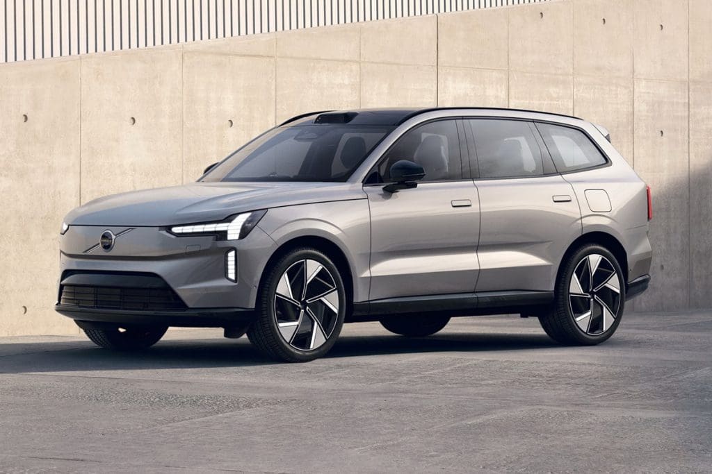 Silver mid-size SUV parked on a paved surface beside a concrete wall, shown from the front-right side.