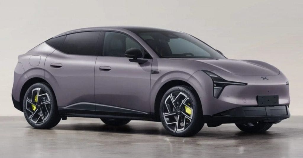 Img4925 | ยางรถยนต์ ราคาอัปเดต 2026 ครบทุกยี่ห้อ รวมยาง Ev | Autotirechecking Side view of a lavender-gray electric SUV with a sloping roof, black glass, and yellow brake calipers in a studio setting.