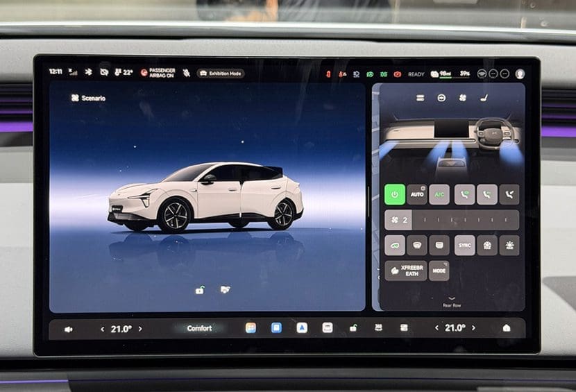 Img4932 | ยางรถยนต์ ราคาอัปเดต 2026 ครบทุกยี่ห้อ รวมยาง Ev | Autotirechecking Infotainment screen in a car showing a white electric SUV on the left and climate/controls panel on the right side.