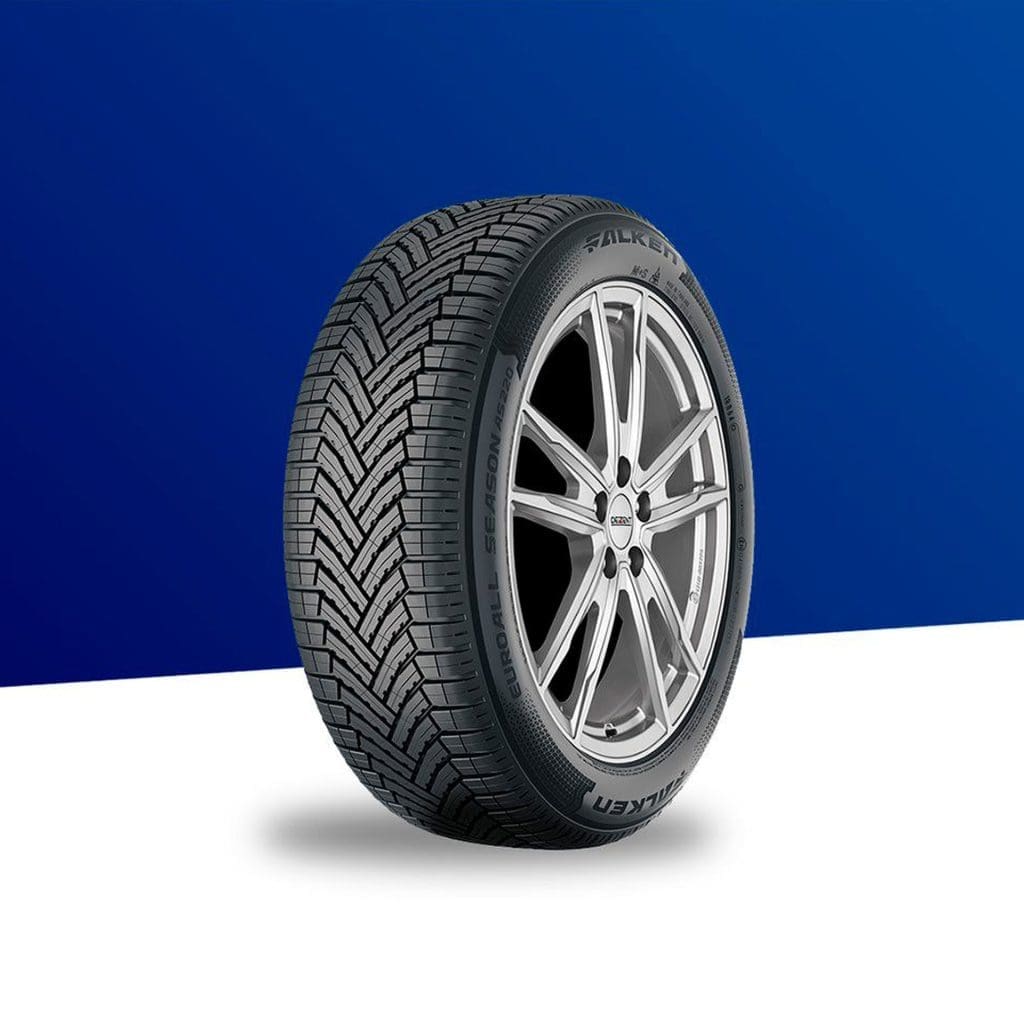 Tire mounted on a silver alloy wheel, diagonal tread pattern, against a blue and white background.