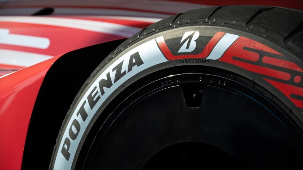Img5030 | ยางรถยนต์ ราคาอัปเดต 2026 ครบทุกยี่ห้อ รวมยาง Ev | Autotirechecking Close-up of a racing car tire showing the Bridgestone Potenza branding on a red vehicle