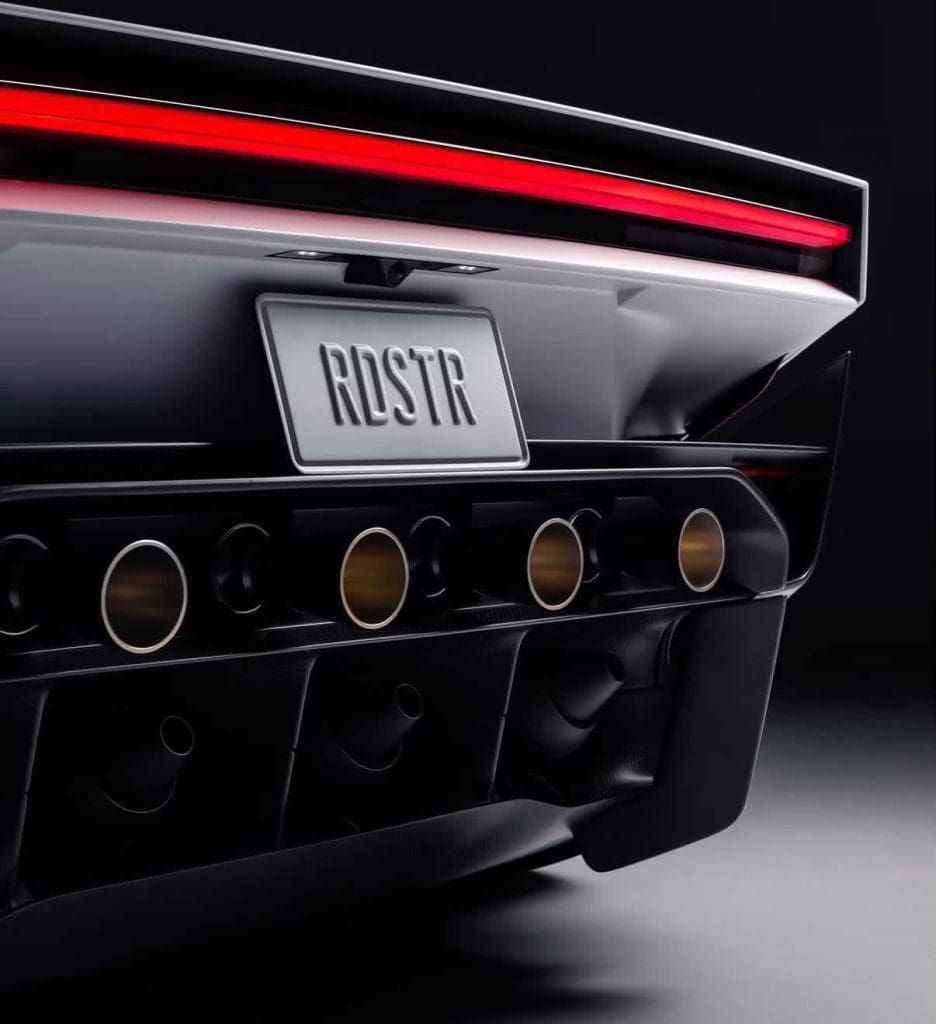 Img5081 | ยางรถยนต์ ราคาอัปเดต 2026 ครบทุกยี่ห้อ รวมยาง Ev | Autotirechecking Rear view of a black car showing a license plate reading 'ROSTR' and multiple round exhaust tips beneath the bumper.