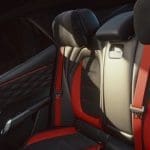 Img5146 | ยางรถยนต์ ราคาอัปเดต 2026 ครบทุกยี่ห้อ รวมยาง Ev | Autotirechecking Rear car seats with red seat belts and black leather upholstery, showing a sporty interior.