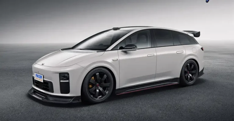 White sport wagon with black wheels, front splitter, and rear wing on a gray asphalt surface.