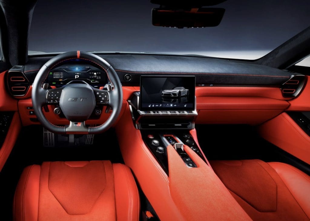 Red leather car interior with a digital instrument cluster, center touchscreen, and sleek center console.